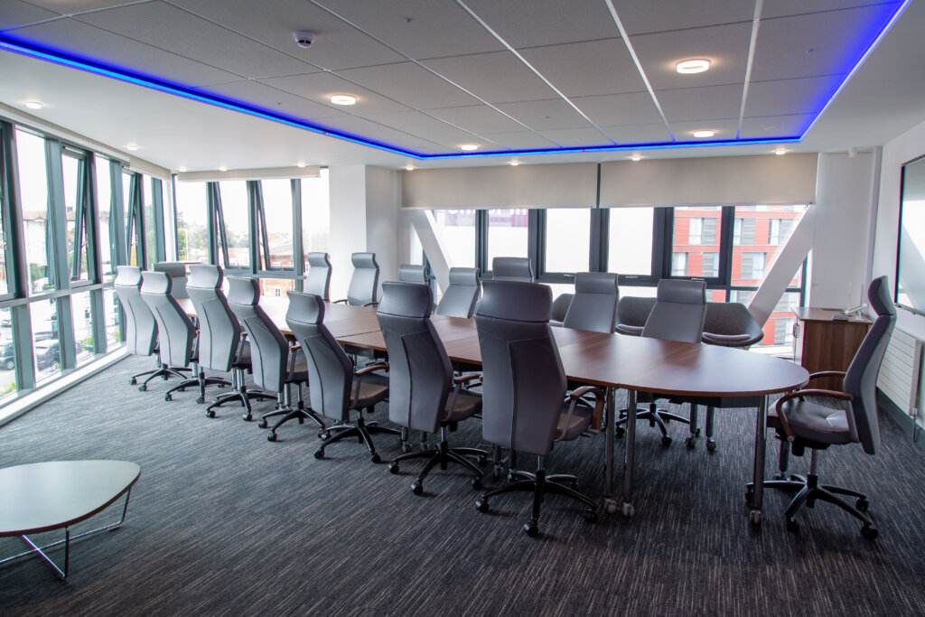 A boardroom table set up for about 14 people