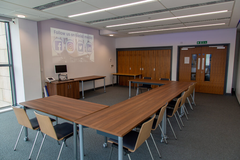 A small event space with desks for around 12 people